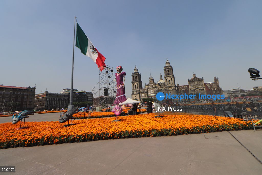A monumental Catrina stands in Mexico City's Zócalo as the centerpiece of the 2026 Ofrenda Monumental. The roughly 32-meter figure, created by the Xibalbá art workshop, was unveiled as part of the Day of the Dead offering, which organizers said set a Guinness World Record for the tallest Catrina. The installation also features pieces from the exhibition "Ajolotes en el Corazón" and cempasúchil flowers. (Photo by Carlos Santiago/JNA Press via Nexpher Images)