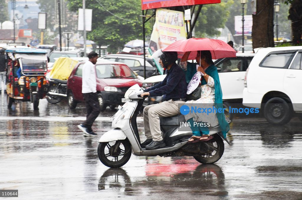 PRAYAGRAJ, INDIA - OCTOBER 30, 2026: Commuters make their way along a rain-soaked street in Prayagraj. (Photo by Saurabh Kumar/JNA Press via Nexpher Images)