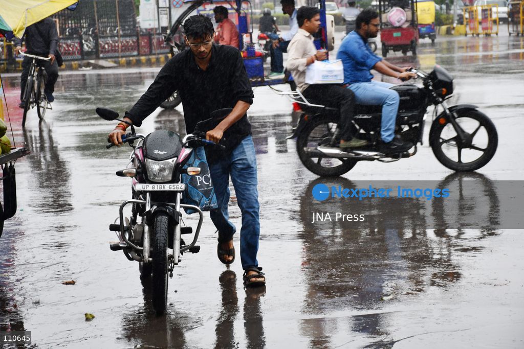 PRAYAGRAJ, INDIA - OCTOBER 30, 2026: Commuters make their way along a rain-soaked street in Prayagraj. (Photo by Saurabh Kumar/JNA Press via Nexpher Images)