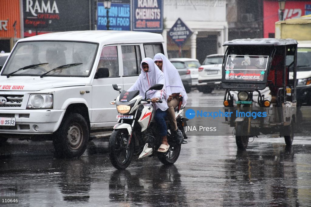 PRAYAGRAJ, INDIA - OCTOBER 30, 2026: Commuters make their way along a rain-soaked street in Prayagraj. (Photo by Saurabh Kumar/JNA Press via Nexpher Images)