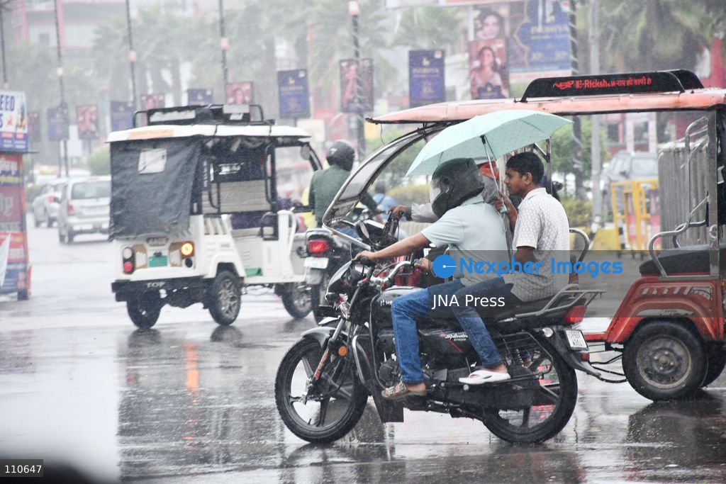 PRAYAGRAJ, INDIA - OCTOBER 30, 2026: Commuters make their way along a rain-soaked street in Prayagraj. (Photo by Saurabh Kumar/JNA Press via Nexpher Images)