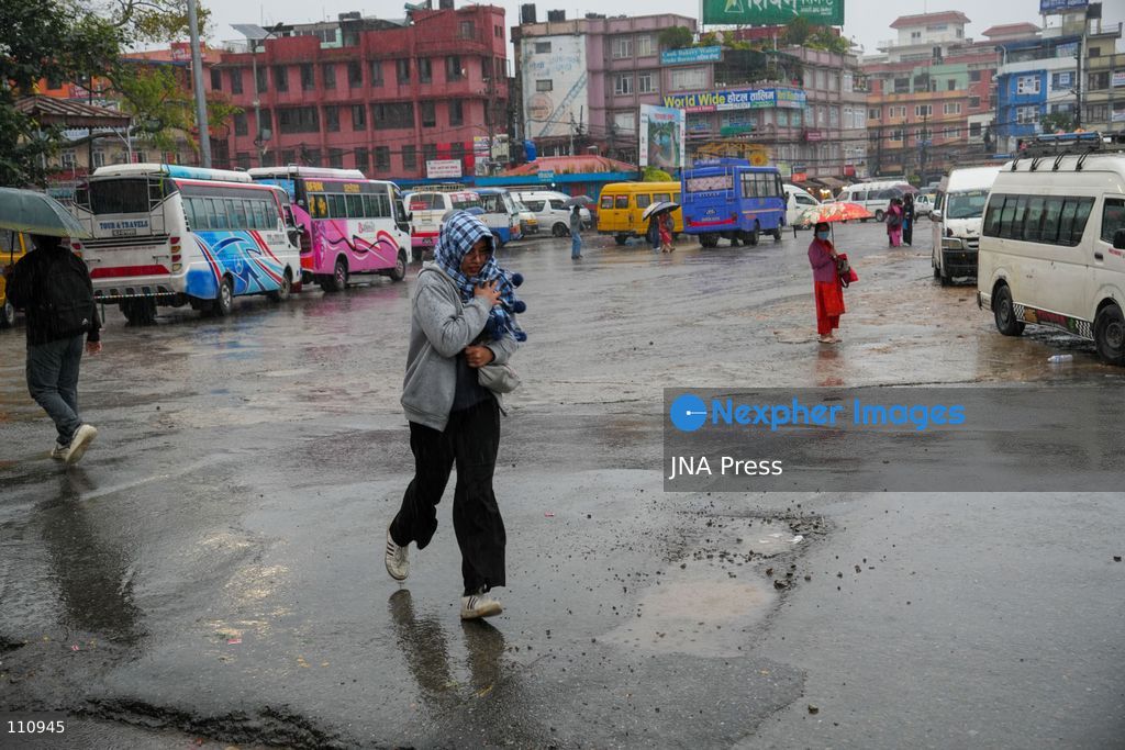 LALITPUR, NEPAL – OCTOBER 31, 2026: People walk through the rain in Lalitpur as Cyclone Arnab, which originated in the Bay of Bengal, brings rainfall to the Kathmandu Valley. Nepal's National Disaster Risk Reduction and Management Authority (NDRRMA) issued a high-alert advisory for 29 to 31 October, urging people to remain on high alert. (Photo by Sunil Pradhan/JNA Press via Nexpher Images)