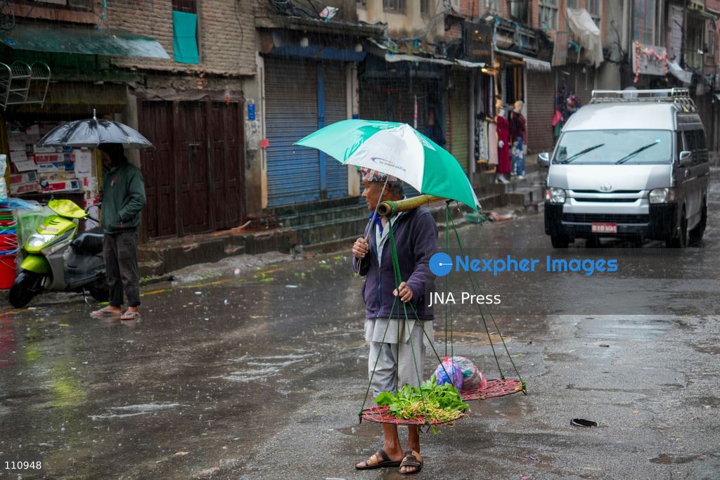 LALITPUR, NEPAL – OCTOBER 31, 2026: People walk through the rain in Lalitpur as Cyclone Arnab, which originated in the Bay of Bengal, brings rainfall to the Kathmandu Valley. Nepal's National Disaster Risk Reduction and Management Authority (NDRRMA) issued a high-alert advisory for 29 to 31 October, urging people to remain on high alert. (Photo by Sunil Pradhan/JNA Press via Nexpher Images)