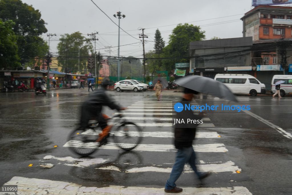 LALITPUR, NEPAL – OCTOBER 31, 2026: People walk through the rain in Lalitpur as Cyclone Arnab, which originated in the Bay of Bengal, brings rainfall to the Kathmandu Valley. Nepal's National Disaster Risk Reduction and Management Authority (NDRRMA) issued a high-alert advisory for 29 to 31 October, urging people to remain on high alert. (Photo by Sunil Pradhan/JNA Press via Nexpher Images)