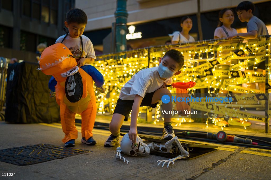 Children playing with a halloween display at a Halloween market in Central District on October 31, 2026 in Hong Kong. (Photo by Vernon Yuen/Nexpher Images)