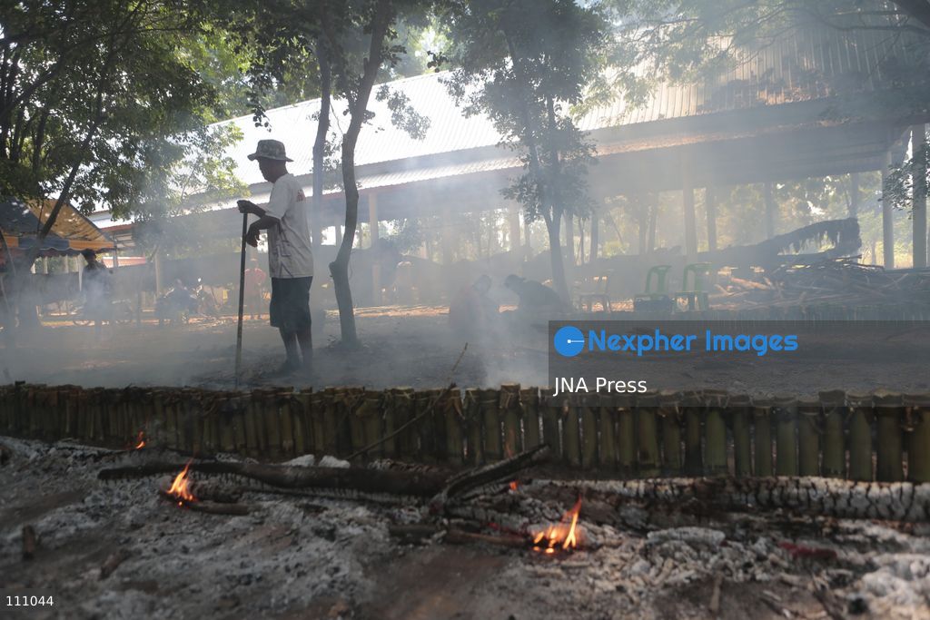 NAKHON SAWAN, THAILAND - OCTOBER 31, 2026: Villagers roast sticky rice in bamboo tubes, known as Khao Lam, at a temple in Nakhon Sawan province, north of Bangkok, ahead of a Kathin ceremony held after the end of Buddhist Lent. The rice is distributed to people who attend the ceremony, in a tradition passed down through generations that encourages villagers to work together. (Photo by Chaiwat Subprasom/JNA Press via Nexpher Images)