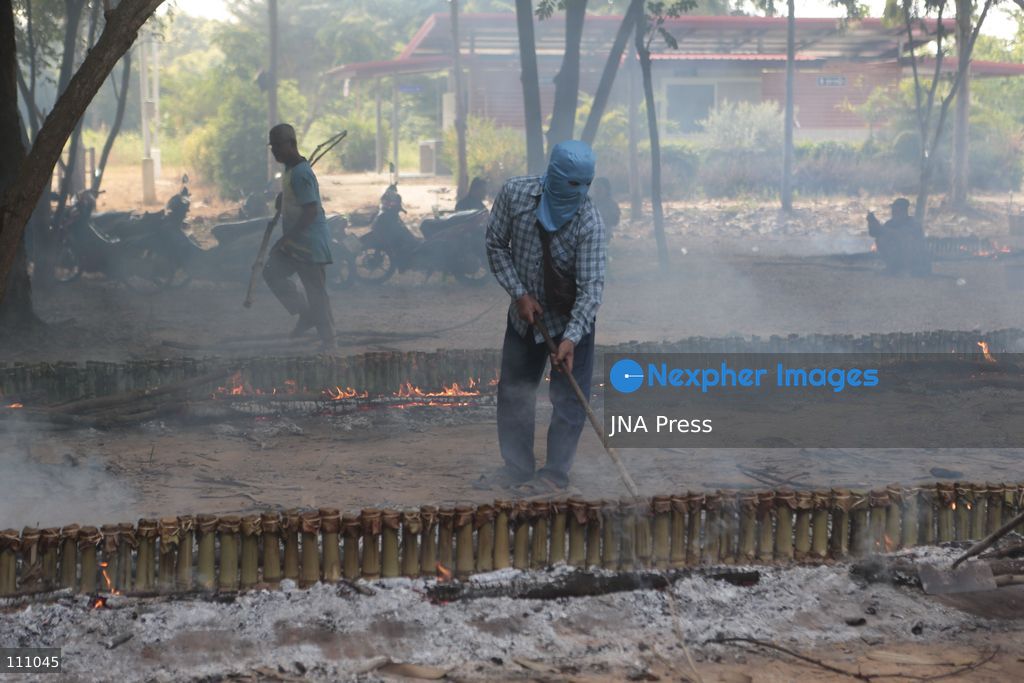 NAKHON SAWAN, THAILAND - OCTOBER 31, 2026: Villagers roast sticky rice in bamboo tubes, known as Khao Lam, at a temple in Nakhon Sawan province, north of Bangkok, ahead of a Kathin ceremony held after the end of Buddhist Lent. The rice is distributed to people who attend the ceremony, in a tradition passed down through generations that encourages villagers to work together. (Photo by Chaiwat Subprasom/JNA Press via Nexpher Images)