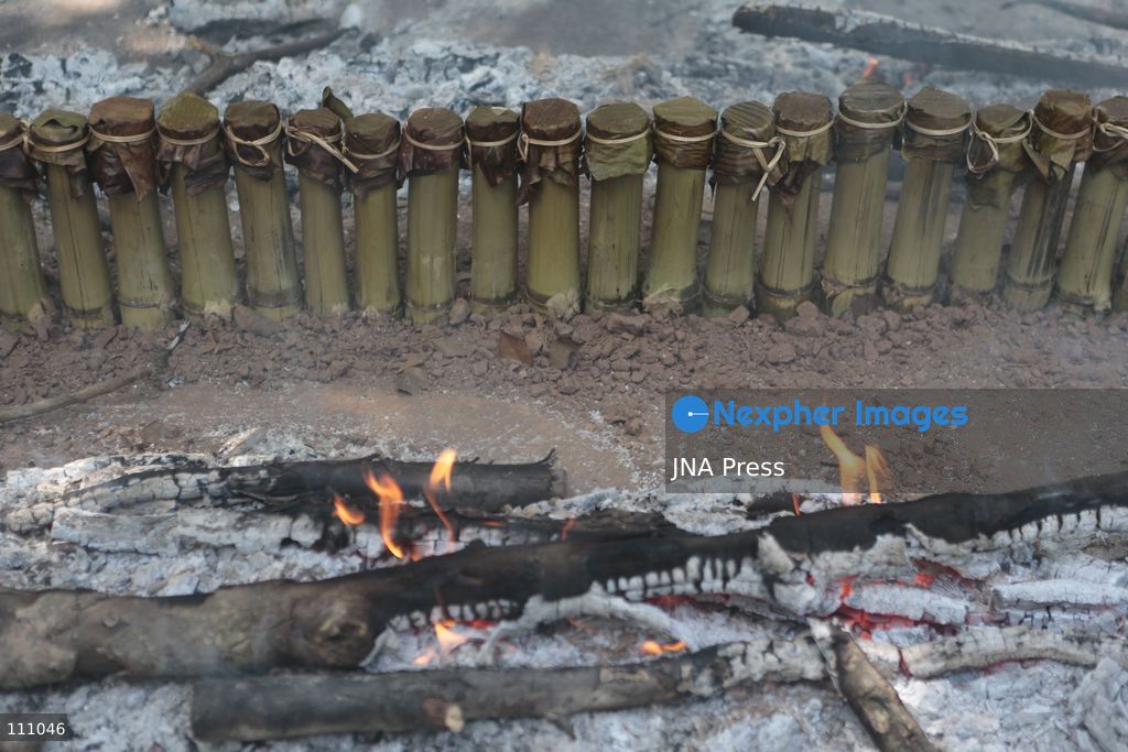 NAKHON SAWAN, THAILAND - OCTOBER 31, 2026: Villagers roast sticky rice in bamboo tubes, known as Khao Lam, at a temple in Nakhon Sawan province, north of Bangkok, ahead of a Kathin ceremony held after the end of Buddhist Lent. The rice is distributed to people who attend the ceremony, in a tradition passed down through generations that encourages villagers to work together. (Photo by Chaiwat Subprasom/JNA Press via Nexpher Images)