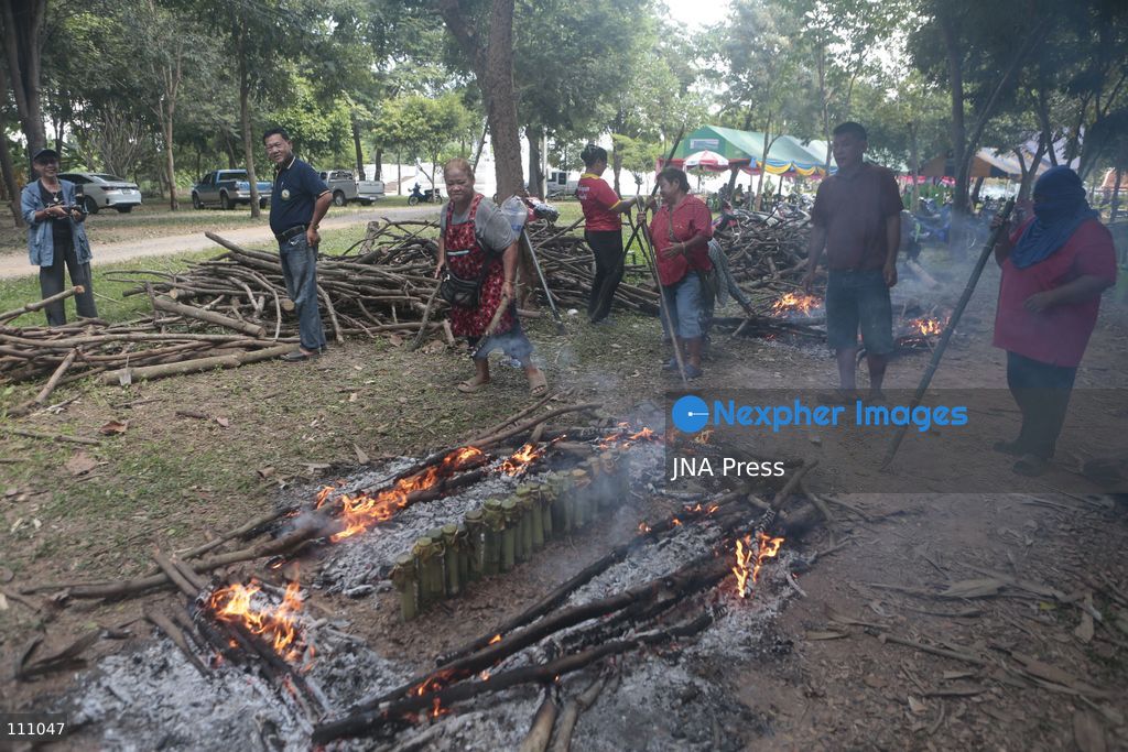 NAKHON SAWAN, THAILAND - OCTOBER 31, 2026: Villagers roast sticky rice in bamboo tubes, known as Khao Lam, at a temple in Nakhon Sawan province, north of Bangkok, ahead of a Kathin ceremony held after the end of Buddhist Lent. The rice is distributed to people who attend the ceremony, in a tradition passed down through generations that encourages villagers to work together. (Photo by Chaiwat Subprasom/JNA Press via Nexpher Images)