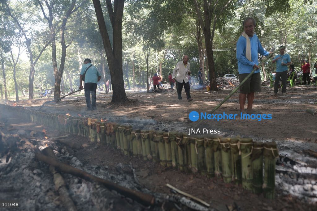NAKHON SAWAN, THAILAND - OCTOBER 31, 2026: Villagers roast sticky rice in bamboo tubes, known as Khao Lam, at a temple in Nakhon Sawan province, north of Bangkok, ahead of a Kathin ceremony held after the end of Buddhist Lent. The rice is distributed to people who attend the ceremony, in a tradition passed down through generations that encourages villagers to work together. (Photo by Chaiwat Subprasom/JNA Press via Nexpher Images)