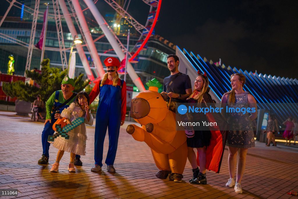 People dress in costumes posing for a photo on October 31, 2026 in Hong Kong. (Photo by Vernon Yuen/Nexpher Images)