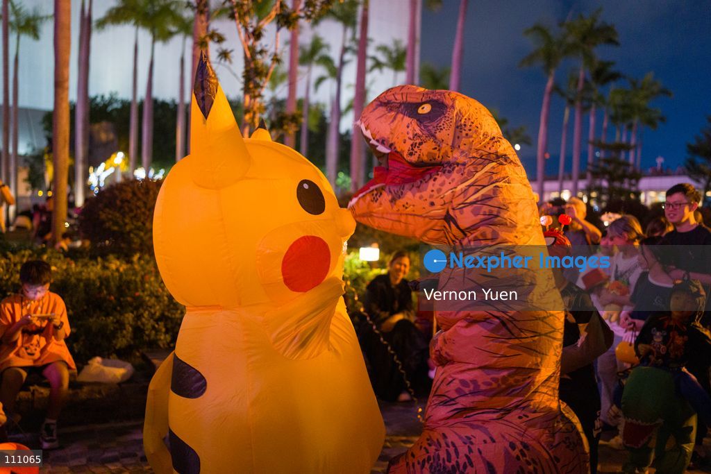 A person in a pikachu costume and a person in a dinosaur costume on October 31, 2026 in Hong Kong. (Photo by Vernon Yuen/Nexpher Images)