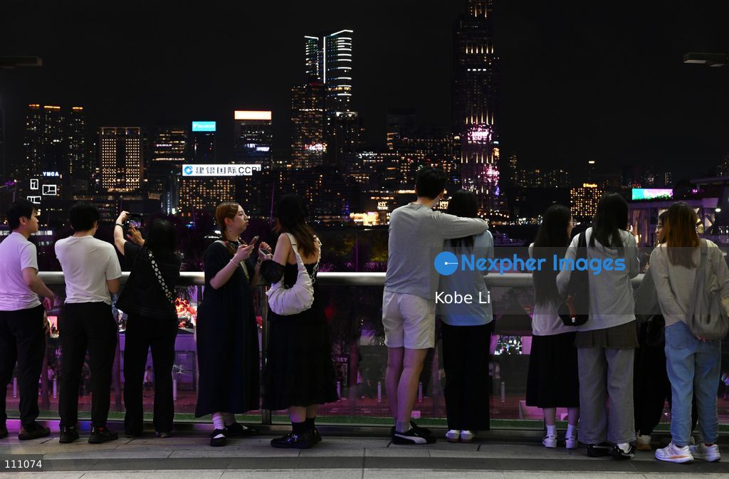 Visitors watching night view of Victoria Harbour during Halloween day at Wan Chai on October 31, 2026 in Hong Kong. (Photo by Kobe Li/Nexpher Images)