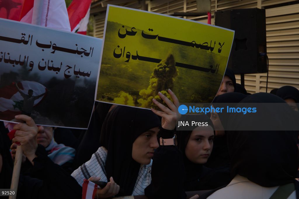 BEIRUT, LEBANON - Sept. 15: A woman holds a sign stating "No silence about aggression" during a protest on Sept. 15, 2026 in Beirut's southern suburbs over Israel's continued destruction of villages in south Lebanon. Photo by Nicholas Frakes / JNA Press (Photo by Nicholas Frakes/JNA Press via Nexpher Images)