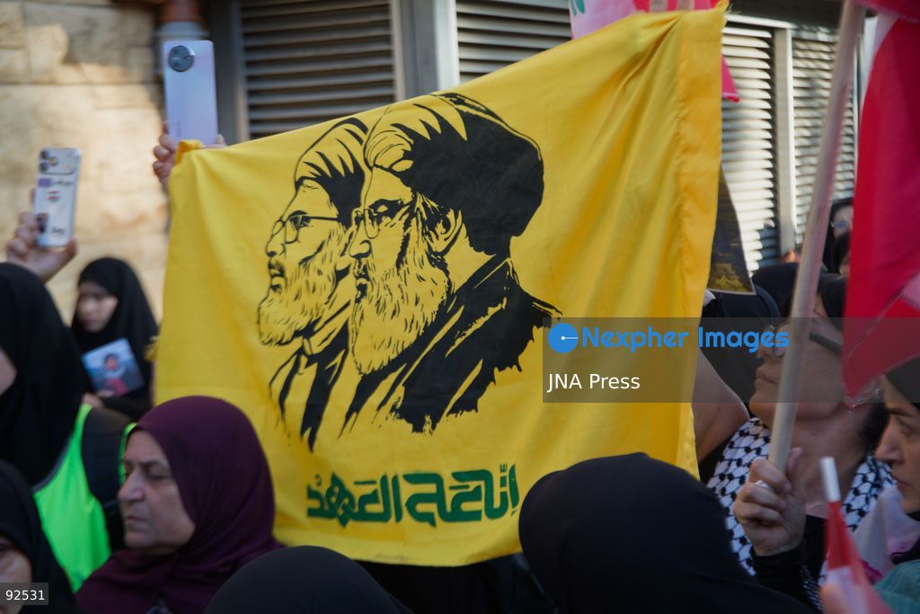 BEIRUT, LEBANON - Sept. 15: A flag depicting Hezbollah's former leader Hassan Nasrallah and his slain successor, Hashem Safiaddine during a protest on Sept. 15, 2026 in Beirut's southern suburbs over Israel's continued destruction of villages in south Lebanon. Photo by Nicholas Frakes / JNA Press (Photo by Nicholas Frakes/JNA Press via Nexpher Images)