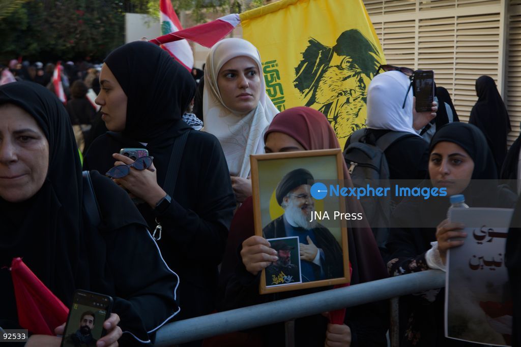 BEIRUT, LEBANON - Sept. 15: A young girl holds a photograph of Hezbollah's former leader Hassan Nasrallah and the group's former military commander Imad Mughniyeh during a protest on Sept. 15, 2026 in Beirut's southern suburbs over Israel's continued destruction of villages in south Lebanon. Photo by Nicholas Frakes / JNA Press (Photo by Nicholas Frakes/JNA Press via Nexpher Images)