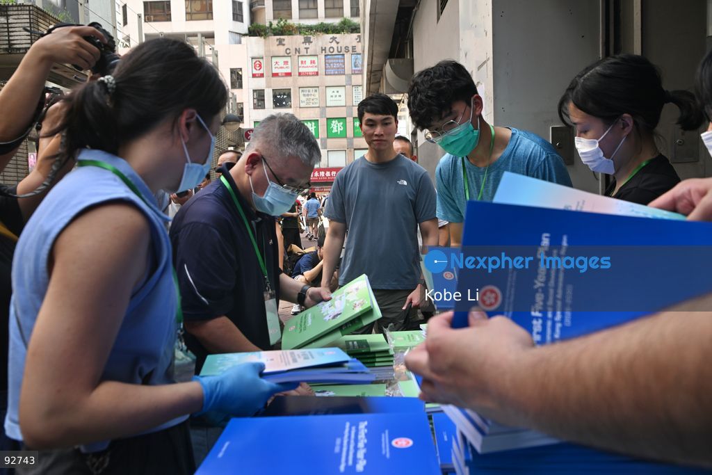Staffs hand out the First Five-Year Plan for Economic and Social Development of the Hong Kong Special Administrative Region (2026-2030) and the Chief Executive's 2026 Policy Address on September 16, 2026 in Hong Kong. (Photo by Kobe Li/Nexpher Images)
