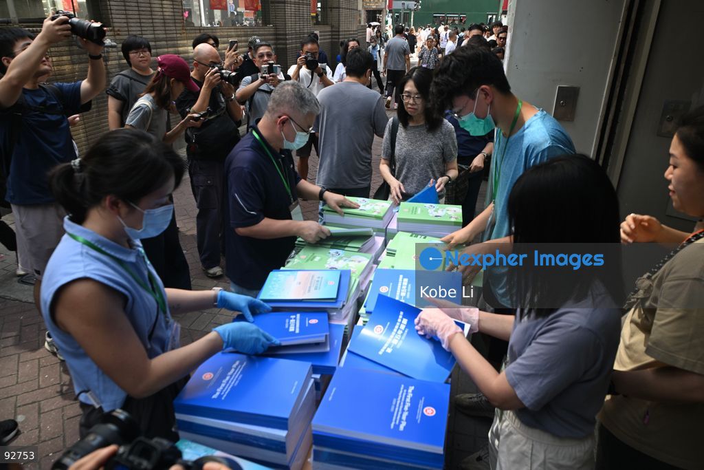 Staffs hand out the First Five-Year Plan for Economic and Social Development of the Hong Kong Special Administrative Region (2026-2030) and the Chief Executive's 2026 Policy Address on September 16, 2026 in Hong Kong. (Photo by Kobe Li/Nexpher Images)
