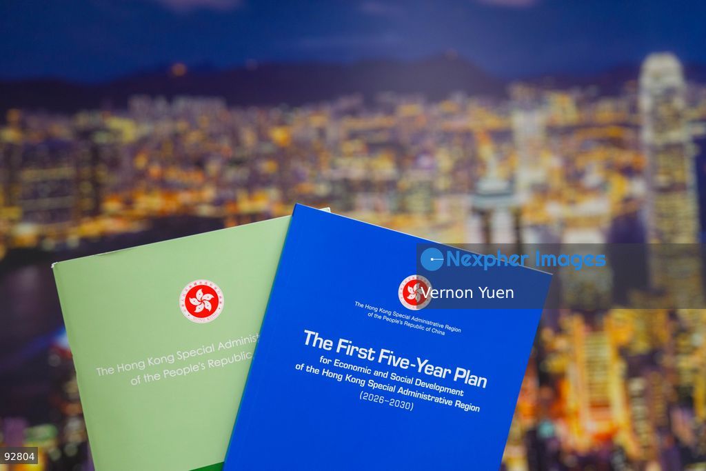 The Hong Kong Chief Executive 2026 Policy Address and the Hong Kong First Five Year plan booklet in front of a photo of the Hong Kong Skyline on September 16, 2026 in Hong Kong. (Photo by Vernon Yuen/Nexpher Images Stock)