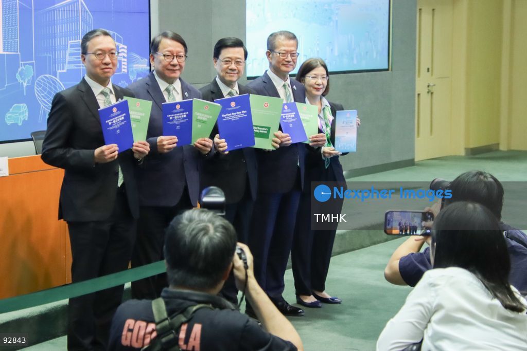Hong Kong Chief Executive John Lee Ka-chiu; Chief Secretary for Administration Chan Kwok-ki; Financial Secretary Paul Chan Mo-po; Secretary for Justice Paul Lam Ting-kwok; and Secretary for Constitutional and Mainland Affairs Janice Tse Siu-wa pose for a photo call holding copies of the 2026 Policy Address and the "First Five-Year Plan of Hong Kong," as photojournalists are seen in the frame directing the officials' attention, during a press (Photo by Gordon Choi/TMHK via Nexpher Images)