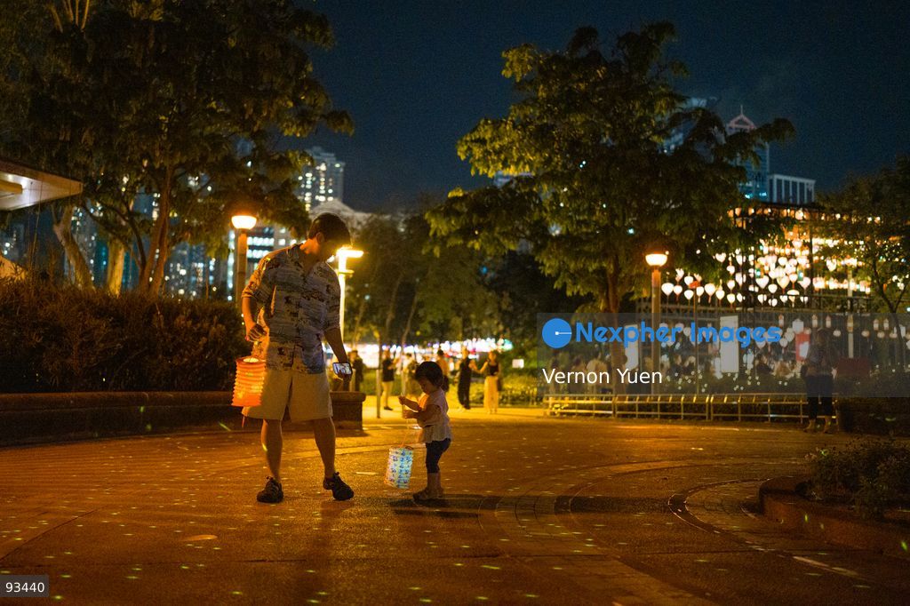 A man and a girl holding lanterns the Mid Autumn Festival Lights at Victoria Park on September 17, 2026 in Hong Kong. (Photo by Vernon Yuen/Nexpher Images)