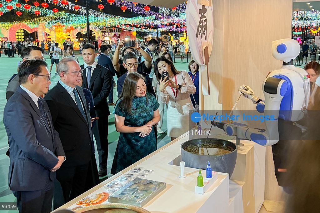 Secretary for Culture, Sports and Tourism Rosanna Law Shuk-pui watches a robotic dog demonstration during her tour of the "International Mid-Autumn Lantern Carnival" at Victoria Park on September 17, 2026 in Hong Kong. (Photo by Peter Tsang/TMHK via Nexpher Images)