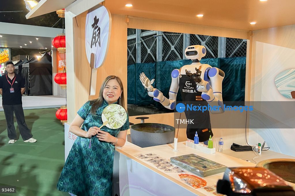 Secretary for Culture, Sports and Tourism Rosanna Law Shuk-pui poses for a photo call with a robotic dog during her visit to the "International Mid-Autumn Lantern Carnival" at Victoria Park on September 17, 2026 in Hong Kong. (Photo by Peter Tsang/TMHK via Nexpher Images)