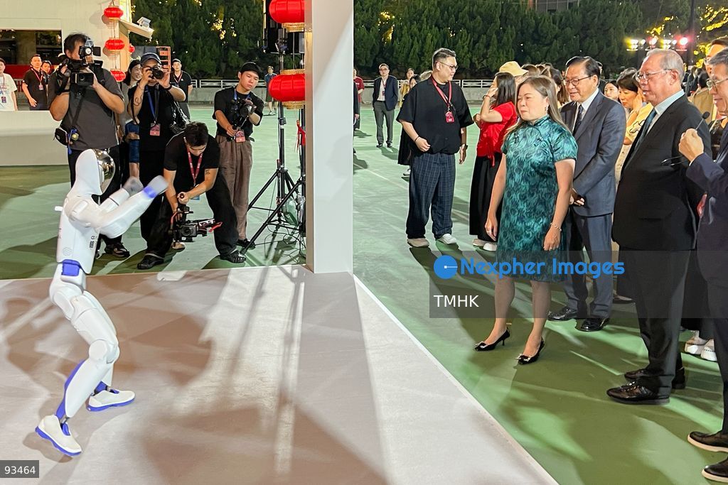 Secretary for Culture, Sports and Tourism Rosanna Law Shuk-pui watches a robotic dog demonstration during her tour of the "International Mid-Autumn Lantern Carnival" at Victoria Park on September 17, 2026 in Hong Kong. (Photo by Peter Tsang/TMHK via Nexpher Images)
