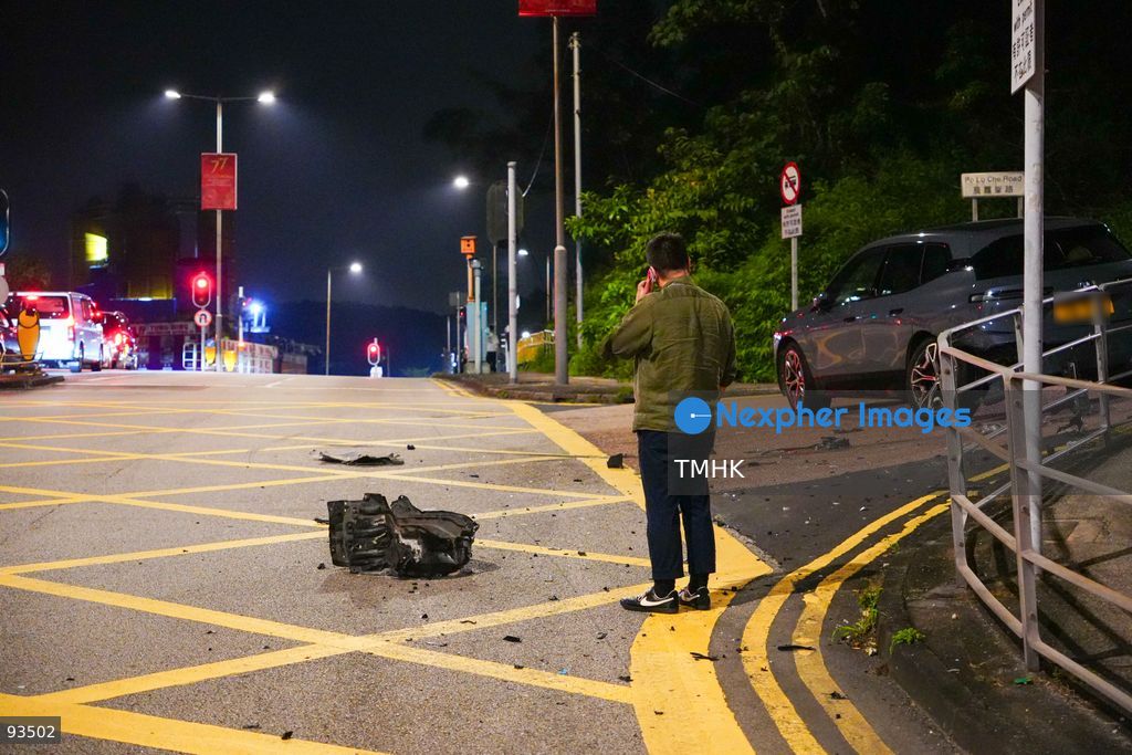 The driver of a damaged BMW iX electric car, its license plate blurred in accordance with privacy practice, makes a phone call beside the vehicle following a traffic accident on Hiram's Highway near Po Lo Che Road on September 17, 2026 in Hong Kong. (Photo by Zulu Lo/TMHK via Nexpher Images)