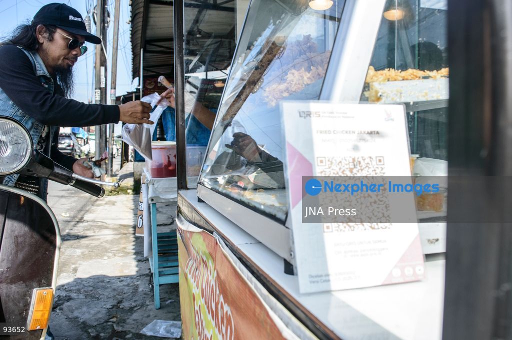 MEDAN, NORTH SUMATRA, INDONESIA, SEPTEMBER 17, 2026: The reflection of musician Jovan Siahaan, 42, appears on a smartphone displaying the Suno AI music platform as he arranges compositions for his digital solo project, Agent AI, in Medan, North Sumatra. Siahaan, who works as the project’s arranger and vocalist, uses artificial intelligence tools during the production process before adding his own vocal recordings to songs addressing social issues. The project is scheduled to perform at the Medanfor Thepunx #6 event. Photo by Sutanta Aditya / JNA Press. (Photo by Sutanta Aditya/JNA Press via Nexpher Images)