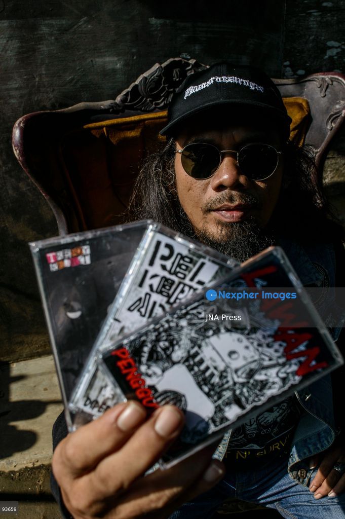 MEDAN, NORTH SUMATRA, INDONESIA, SEPTEMBER 17, 2026: The reflection of musician Jovan Siahaan, 42, appears on a smartphone displaying the Suno AI music platform as he arranges compositions for his digital solo project, Agent AI, in Medan, North Sumatra. Siahaan, who works as the project’s arranger and vocalist, uses artificial intelligence tools during the production process before adding his own vocal recordings to songs addressing social issues. The project is scheduled to perform at the Medanfor Thepunx #6 event. Photo by Sutanta Aditya / JNA Press. (Photo by Sutanta Aditya/JNA Press via Nexpher Images)