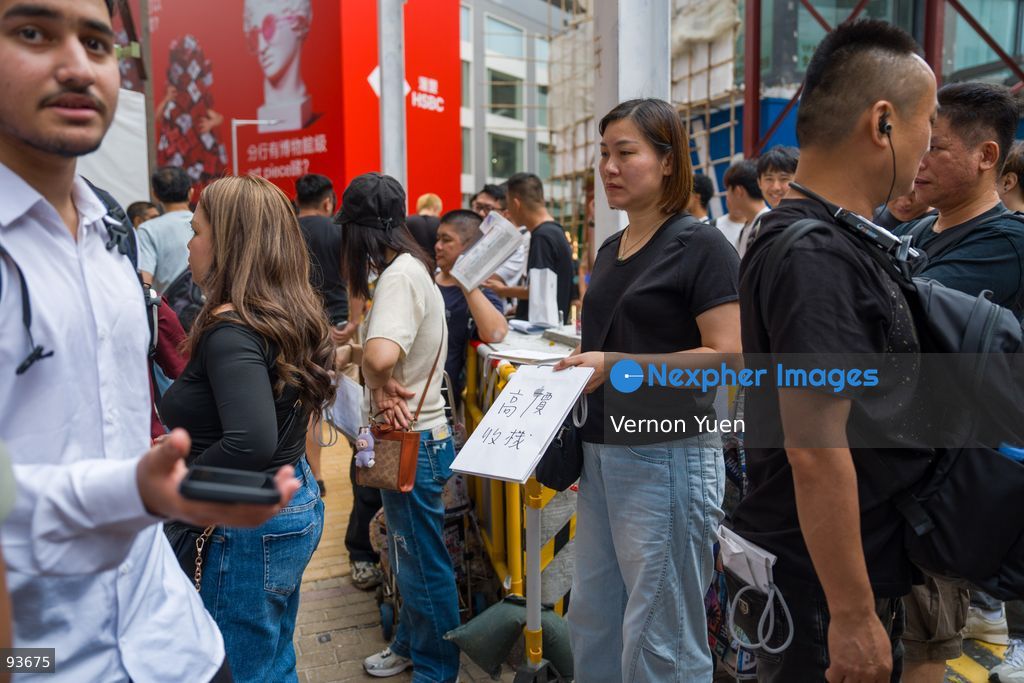 An iphone reseller outside an apple store on the first day on sale of the iphone 18 pro on September 18, 2026 in Hong Kong. (Photo by Vernon Yuen/Nexpher Images)