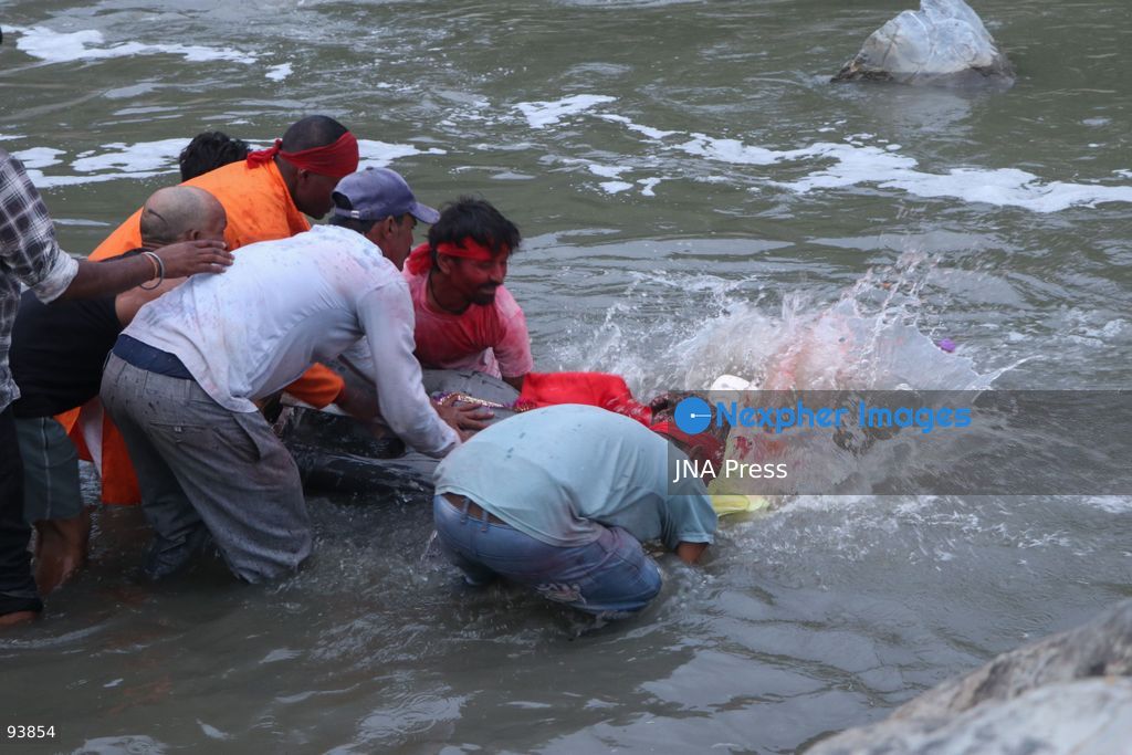 KATHMANDU, NEPAL, SEPTEMBER 18, 2026: Hindu devotees carry and immerse idols of Lord Vishwakarma in the Bagmati River at Chobhar in Kathmandu, marking the conclusion of annual Vishwakarma Puja celebrations. Worshippers perform traditional rituals, offer prayers and smear colored powder on one another before lowering clay idols into the river. Vishwakarma Puja is observed by artisans, mechanics and industrial workers, who traditionally worship their tools, machinery and vehicles in honor of the Hindu deity associated with architecture and craftsmanship. Photo by Shankar Bhujel / JNA Press. (Photo by Shankar Bhujel/JNA Press via Nexpher Images)