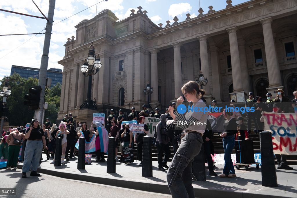 MELBOURNE, AUSTRALIA, SEPTEMBER 19, 2026: Transgender rights supporters demonstrate outside the Parliament of Victoria in Melbourne amid a heavy police presence. Tensions rise as protesters confront bodyguards accompanying Avi Yemini while he attempts to interview people opposing the demonstration. Photo by Braden Nam / JNA Press. (Photo by Taemin Braden Nam/JNA Press via Nexpher Images)