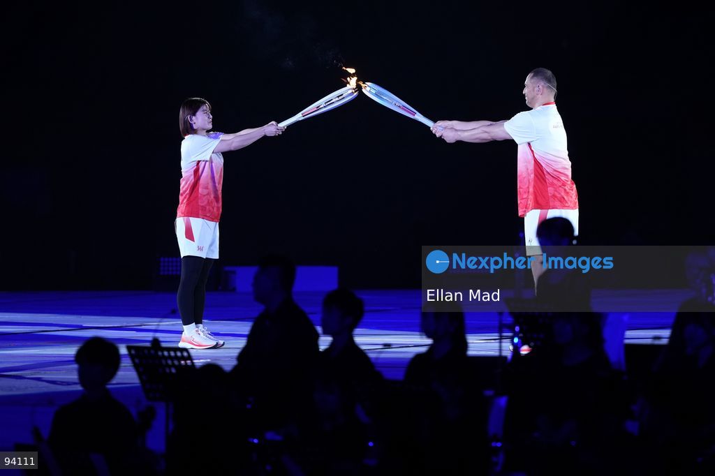 Koji Murofushi, Japanese former hammer thrower pass the flame to Ayaka Takahashi, retired Japanese badminton player at the 2026 Asian Games opening ceremony on September 19, 2026 in Nagoya, Japan (Photo by Ellan Mad/Nexpher Images)