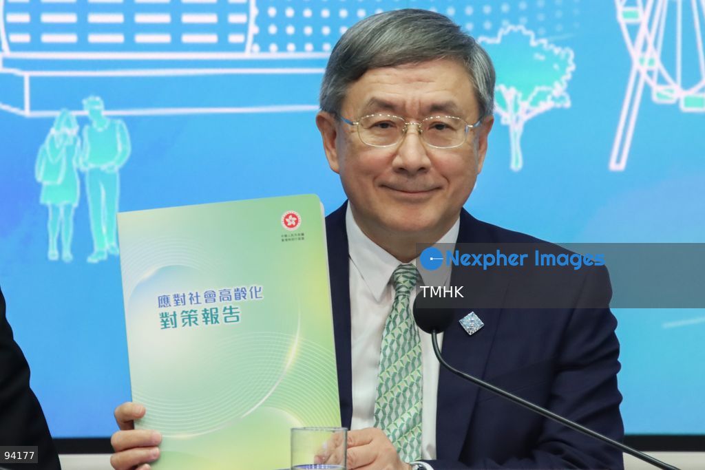 A close-up view shows Deputy Chief Secretary for Administration Warner Cheuk Wing-hing holding a copy of the "Report on Ageing Society Strategies" during a press conference on the 2026 Policy Address and the "First Five-Year Plan of Hong Kong" on September 18, 2026 in Hong Kong. Cheuk, who leads the Working Group on Ageing Society Strategies, announced 73 strategic measures across 11 key areas to address long-term demographic challenges as the city projects over one-third of its population to be aged 65 and above by 2046. (Photo by Gordon Choi/TMHK via Nexpher Images)