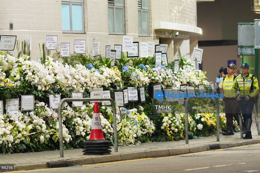 Floral wreaths and tributes sent by dignitaries and various sectors of the community line the entrance and pavement outside the Hong Kong Funeral Home during the wake for former Chief Executive Tung Chee-hwa on September 19, 2026 in Hong Kong. (Photo by Zulu Lo/TMHK via Nexpher Images)