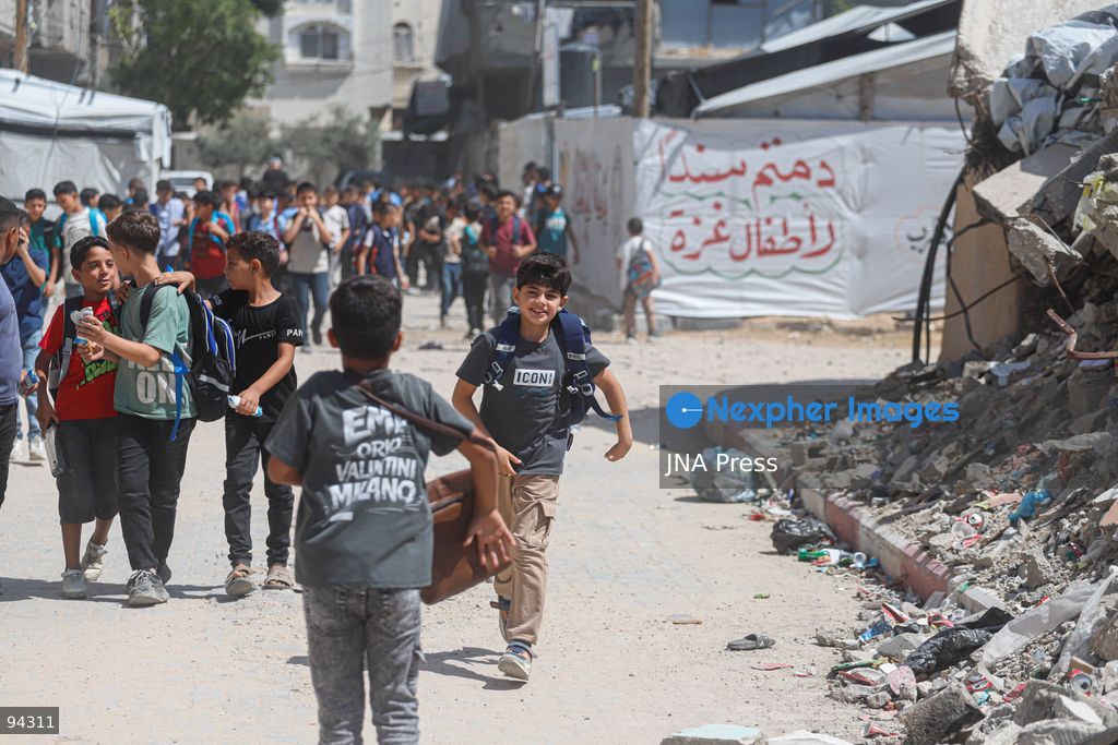 GAZA CITY, GAZA STRIP, SEPTEMBER 19, 2026: Palestinian students arrive at Al-Itqan School, operating from tents in the Al-Saftawi neighborhood of northern Gaza City, as the new academic year begins across the Gaza Strip. Education is resuming through schools and temporary learning spaces amid widespread damage to educational infrastructure and years of disruption caused by the war. Photo by Ramez Habboub / JNA Press. (Photo by Ramez Habboub/JNA Press via Nexpher Images)
