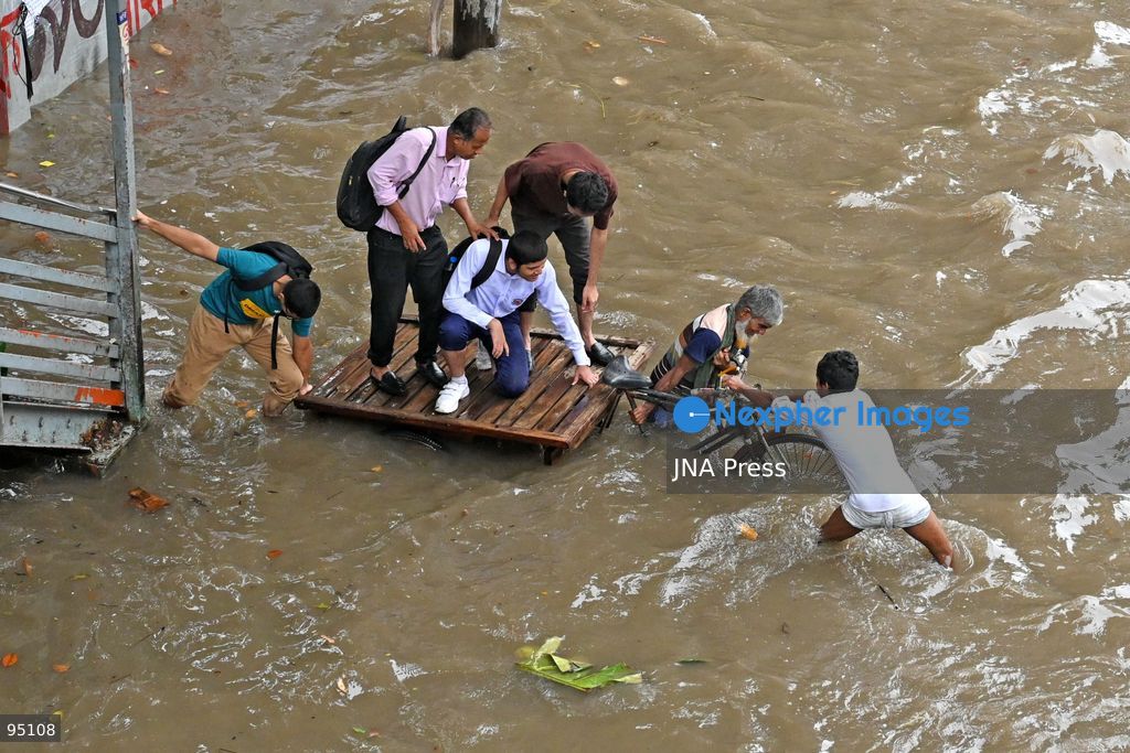 DHAKA, BANGLADESH, SEPTEMBER 20, 2026: Vehicles and passengers navigate waterlogged streets in Dhaka following heavy rainfall in the Bangladeshi capital. Floodwater submerged sections of roads across the city, disrupting traffic and making travel difficult for residents and commuters. Photo by Mamunur Rashid/ JNA Press. (Photo by Mamunur Rashid/JNA Press via Nexpher Images)