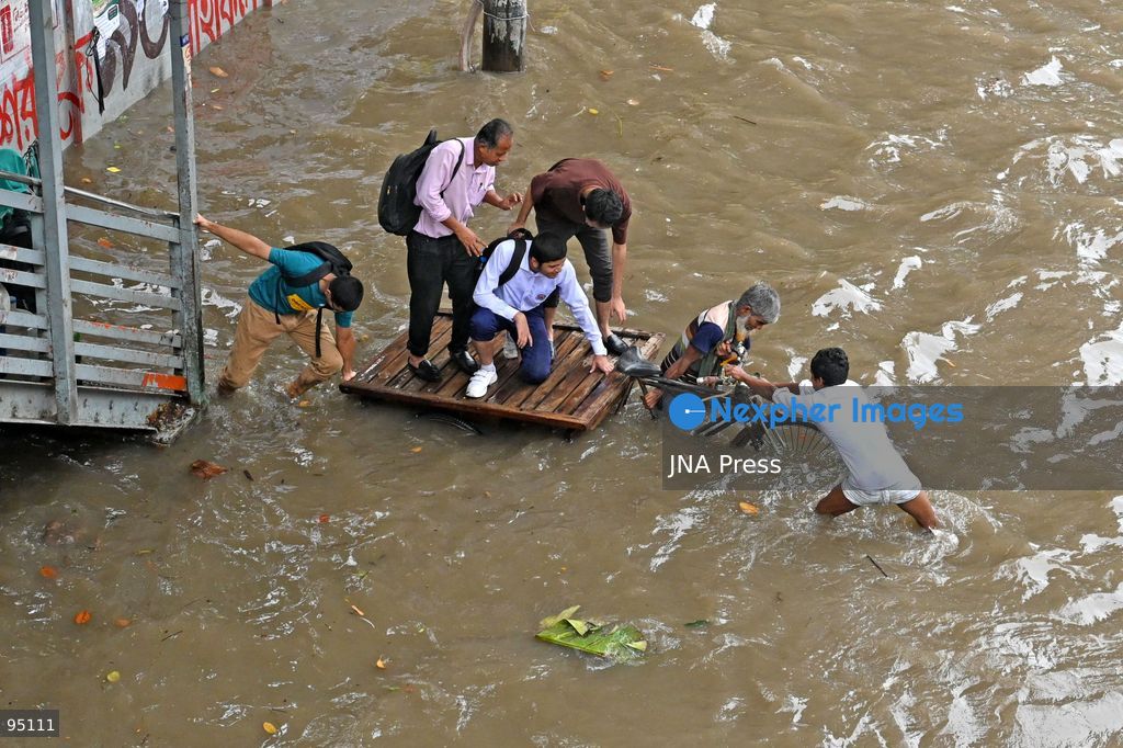 DHAKA, BANGLADESH, SEPTEMBER 20, 2026: Vehicles and passengers navigate waterlogged streets in Dhaka following heavy rainfall in the Bangladeshi capital. Floodwater submerged sections of roads across the city, disrupting traffic and making travel difficult for residents and commuters. Photo by Mamunur Rashid/ JNA Press. (Photo by Mamunur Rashid/JNA Press via Nexpher Images)