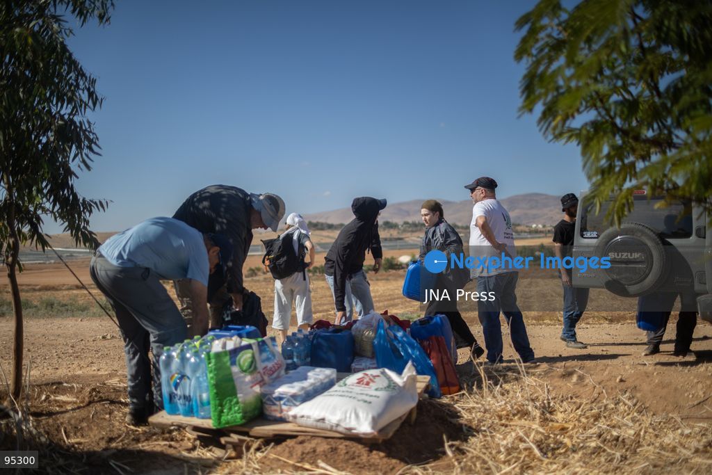 RAS AL-AHMAR, TUBAS, OCCUPIED WEST BANK, SEPTEMBER 20, 2026: Solidarity activists deliver food and water supplies to Palestinian residents of Ras al-Ahmar, southeast of Tubas, as Israeli forces continue to restrict access to the community by closing entrances and digging trenches. The area has seen months of earthworks linked to the construction of a military road planned to extend about 22 kilometers between the Ein Shibli and Tayasir checkpoints. Local officials say previous earthworks have damaged water infrastructure and restricted residents’ access to their land and livelihoods. Photo by Roman Levin / JNA Press. (Photo by Roman Levin/JNA Press via Nexpher Images)