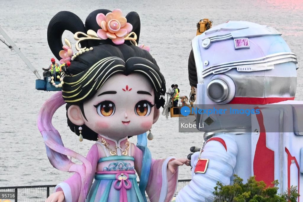 Construction workers working on a large cartoon character Hanfu and astronaut sculpture near the Victoria Harbour on September 22, 2026 in Hong Kong. (Photo by Kobe Li/Nexpher Images)