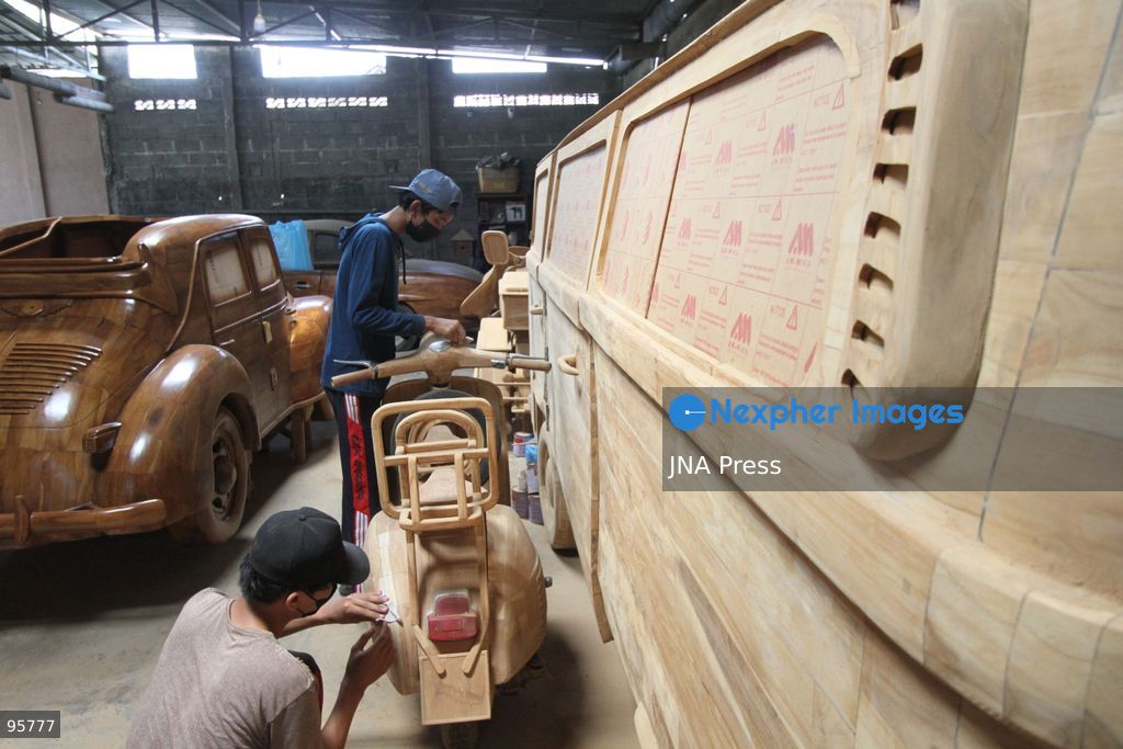 BOYOLALI, INDONESIA — SEPTEMBER 22, 2026: A worker applies a layer of varnish to a 1:1 scale wooden car and Harley-Davidson replica made from teak wood at Tetap Jaya Art Industrial House in Kemiri Village, Mojosongo District, Boyolali Regency, Central Java. The 1:1 scale vehicles take approximately one and a half months to complete, while smaller models take about two weeks. The products are ordered by buyers from several European countries at prices reaching tens of millions of rupiah. Mercedes-Benz, Renault, Ford, and Volkswagen cars, as well as Harley-Davidson and Vespa motorcycles, are among the customers' favorite models in European countries. Photo by Agung Mardika / JNA Press. (Photo by JNA EDITOR/JNA Press via Nexpher Images)