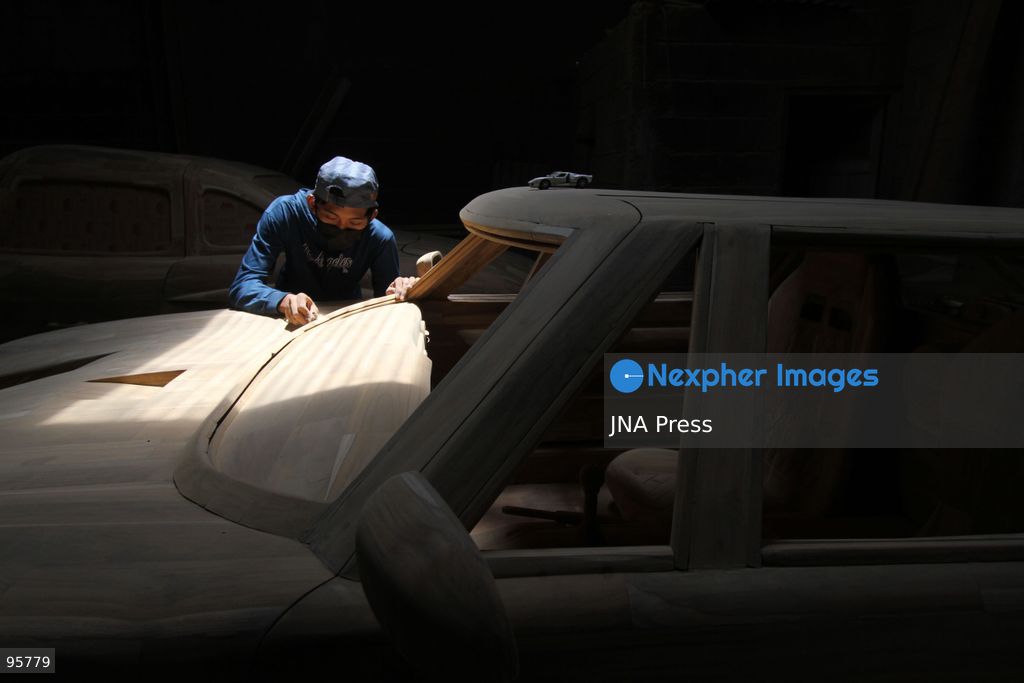 BOYOLALI, INDONESIA — SEPTEMBER 22, 2026: A worker applies a layer of varnish to a 1:1 scale wooden car and Harley-Davidson replica made from teak wood at Tetap Jaya Art Industrial House in Kemiri Village, Mojosongo District, Boyolali Regency, Central Java. The 1:1 scale vehicles take approximately one and a half months to complete, while smaller models take about two weeks. The products are ordered by buyers from several European countries at prices reaching tens of millions of rupiah. Mercedes-Benz, Renault, Ford, and Volkswagen cars, as well as Harley-Davidson and Vespa motorcycles, are among the customers' favorite models in European countries. Photo by Agung Mardika / JNA Press. (Photo by JNA EDITOR/JNA Press via Nexpher Images)