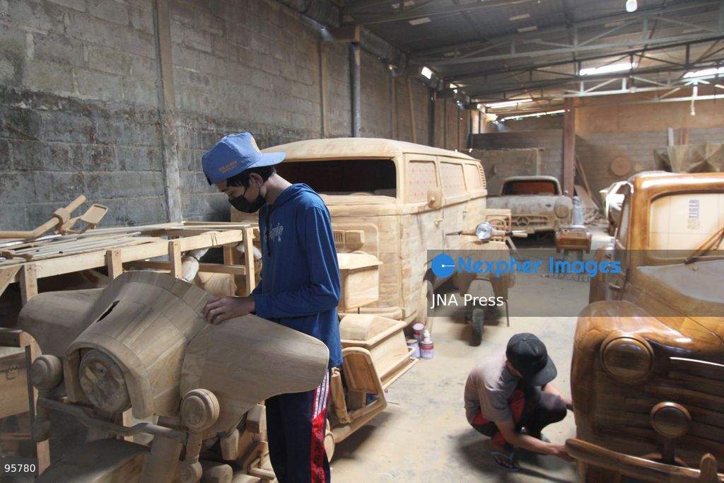 BOYOLALI, INDONESIA — SEPTEMBER 22, 2026: A worker applies a layer of varnish to a 1:1 scale wooden car and Harley-Davidson replica made from teak wood at Tetap Jaya Art Industrial House in Kemiri Village, Mojosongo District, Boyolali Regency, Central Java. The 1:1 scale vehicles take approximately one and a half months to complete, while smaller models take about two weeks. The products are ordered by buyers from several European countries at prices reaching tens of millions of rupiah. Mercedes-Benz, Renault, Ford, and Volkswagen cars, as well as Harley-Davidson and Vespa motorcycles, are among the customers' favorite models in European countries. Photo by Agung Mardika / JNA Press. (Photo by JNA EDITOR/JNA Press via Nexpher Images)