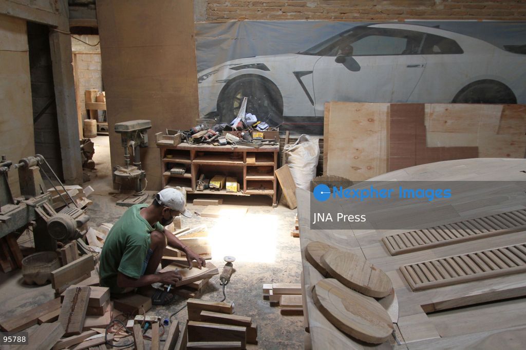 BOYOLALI, INDONESIA — SEPTEMBER 22, 2026: A worker applies a layer of varnish to a 1:1 scale wooden car and Harley-Davidson replica made from teak wood at Tetap Jaya Art Industrial House in Kemiri Village, Mojosongo District, Boyolali Regency, Central Java. The 1:1 scale vehicles take approximately one and a half months to complete, while smaller models take about two weeks. The products are ordered by buyers from several European countries at prices reaching tens of millions of rupiah. Mercedes-Benz, Renault, Ford, and Volkswagen cars, as well as Harley-Davidson and Vespa motorcycles, are among the customers' favorite models in European countries. Photo by Agung Mardika / JNA Press. (Photo by JNA EDITOR/JNA Press via Nexpher Images)