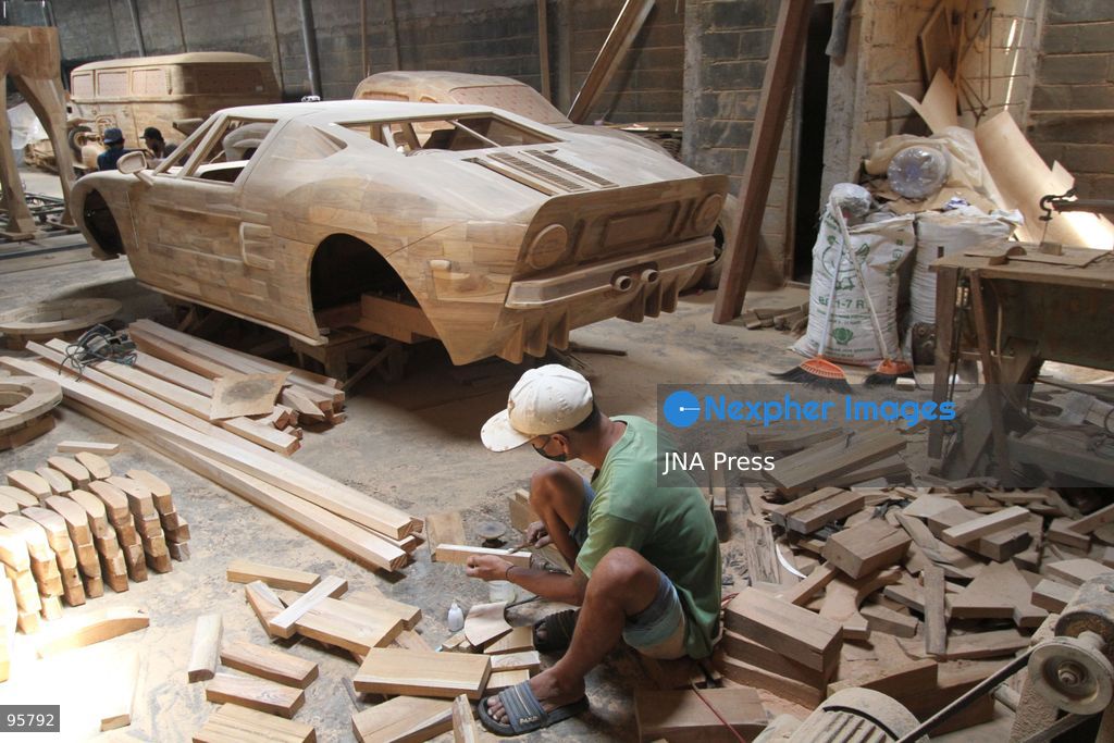 BOYOLALI, INDONESIA — SEPTEMBER 22, 2026: A worker applies a layer of varnish to a 1:1 scale wooden car and Harley-Davidson replica made from teak wood at Tetap Jaya Art Industrial House in Kemiri Village, Mojosongo District, Boyolali Regency, Central Java. The 1:1 scale vehicles take approximately one and a half months to complete, while smaller models take about two weeks. The products are ordered by buyers from several European countries at prices reaching tens of millions of rupiah. Mercedes-Benz, Renault, Ford, and Volkswagen cars, as well as Harley-Davidson and Vespa motorcycles, are among the customers' favorite models in European countries. Photo by Agung Mardika / JNA Press. (Photo by JNA EDITOR/JNA Press via Nexpher Images)