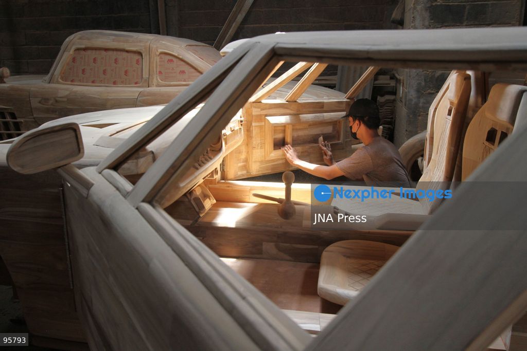 BOYOLALI, INDONESIA — SEPTEMBER 22, 2026: A worker applies a layer of varnish to a 1:1 scale wooden car and Harley-Davidson replica made from teak wood at Tetap Jaya Art Industrial House in Kemiri Village, Mojosongo District, Boyolali Regency, Central Java. The 1:1 scale vehicles take approximately one and a half months to complete, while smaller models take about two weeks. The products are ordered by buyers from several European countries at prices reaching tens of millions of rupiah. Mercedes-Benz, Renault, Ford, and Volkswagen cars, as well as Harley-Davidson and Vespa motorcycles, are among the customers' favorite models in European countries. Photo by Agung Mardika / JNA Press. (Photo by JNA EDITOR/JNA Press via Nexpher Images)