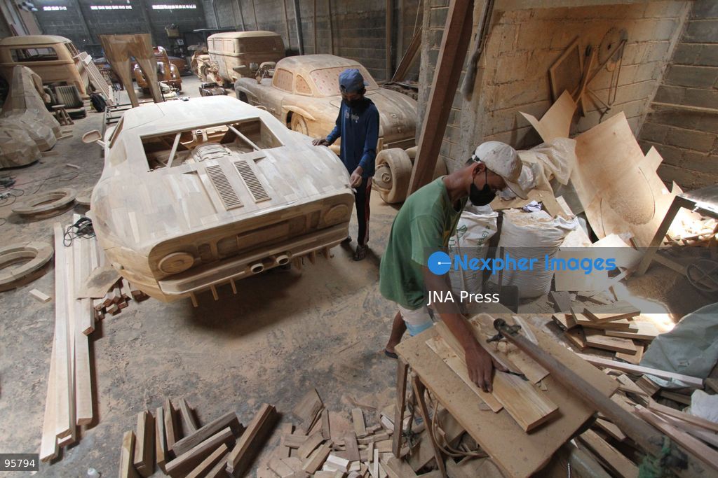 BOYOLALI, INDONESIA — SEPTEMBER 22, 2026: A worker applies a layer of varnish to a 1:1 scale wooden car and Harley-Davidson replica made from teak wood at Tetap Jaya Art Industrial House in Kemiri Village, Mojosongo District, Boyolali Regency, Central Java. The 1:1 scale vehicles take approximately one and a half months to complete, while smaller models take about two weeks. The products are ordered by buyers from several European countries at prices reaching tens of millions of rupiah. Mercedes-Benz, Renault, Ford, and Volkswagen cars, as well as Harley-Davidson and Vespa motorcycles, are among the customers' favorite models in European countries. Photo by Agung Mardika / JNA Press. (Photo by JNA EDITOR/JNA Press via Nexpher Images)