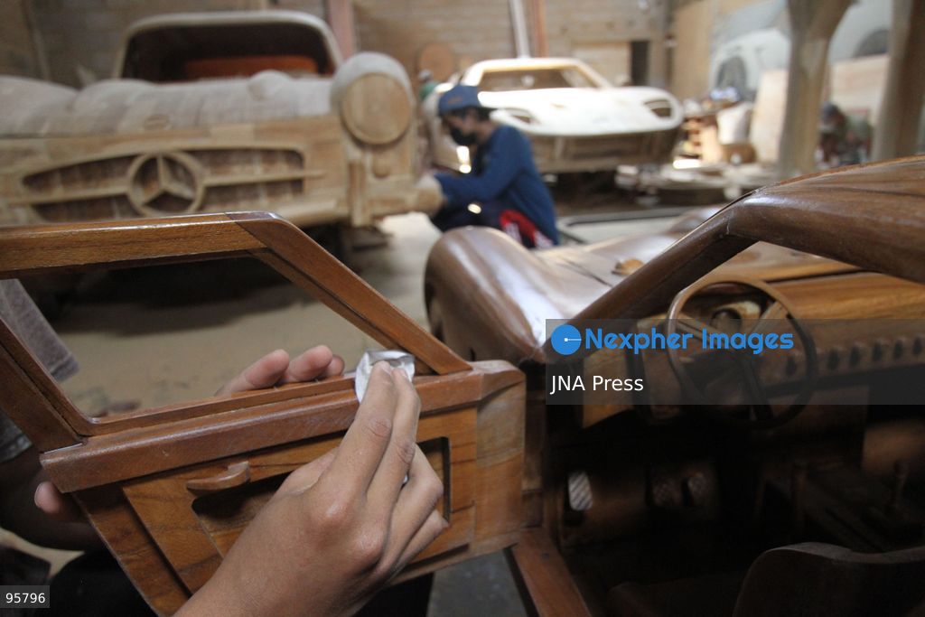 BOYOLALI, INDONESIA — SEPTEMBER 22, 2026: A worker applies a layer of varnish to a 1:1 scale wooden car and Harley-Davidson replica made from teak wood at Tetap Jaya Art Industrial House in Kemiri Village, Mojosongo District, Boyolali Regency, Central Java. The 1:1 scale vehicles take approximately one and a half months to complete, while smaller models take about two weeks. The products are ordered by buyers from several European countries at prices reaching tens of millions of rupiah. Mercedes-Benz, Renault, Ford, and Volkswagen cars, as well as Harley-Davidson and Vespa motorcycles, are among the customers' favorite models in European countries. Photo by Agung Mardika / JNA Press. (Photo by JNA EDITOR/JNA Press via Nexpher Images)